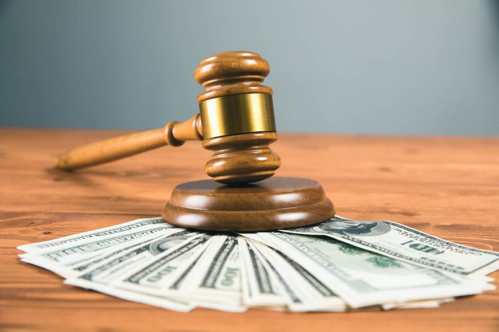 The judge's gavel and the money you will need to pay to file for divorce